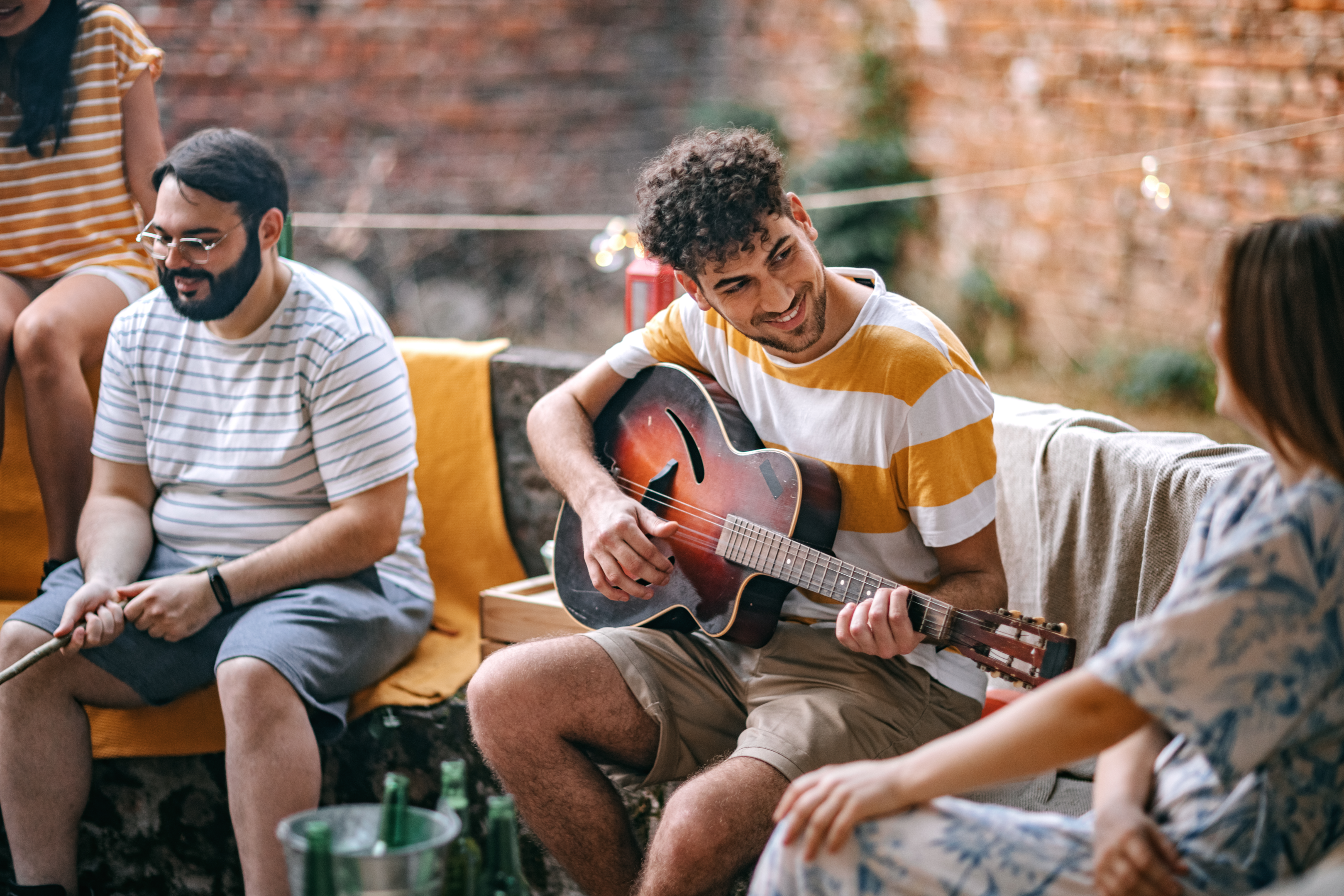 People enjoying live music and a guy playing a guitar