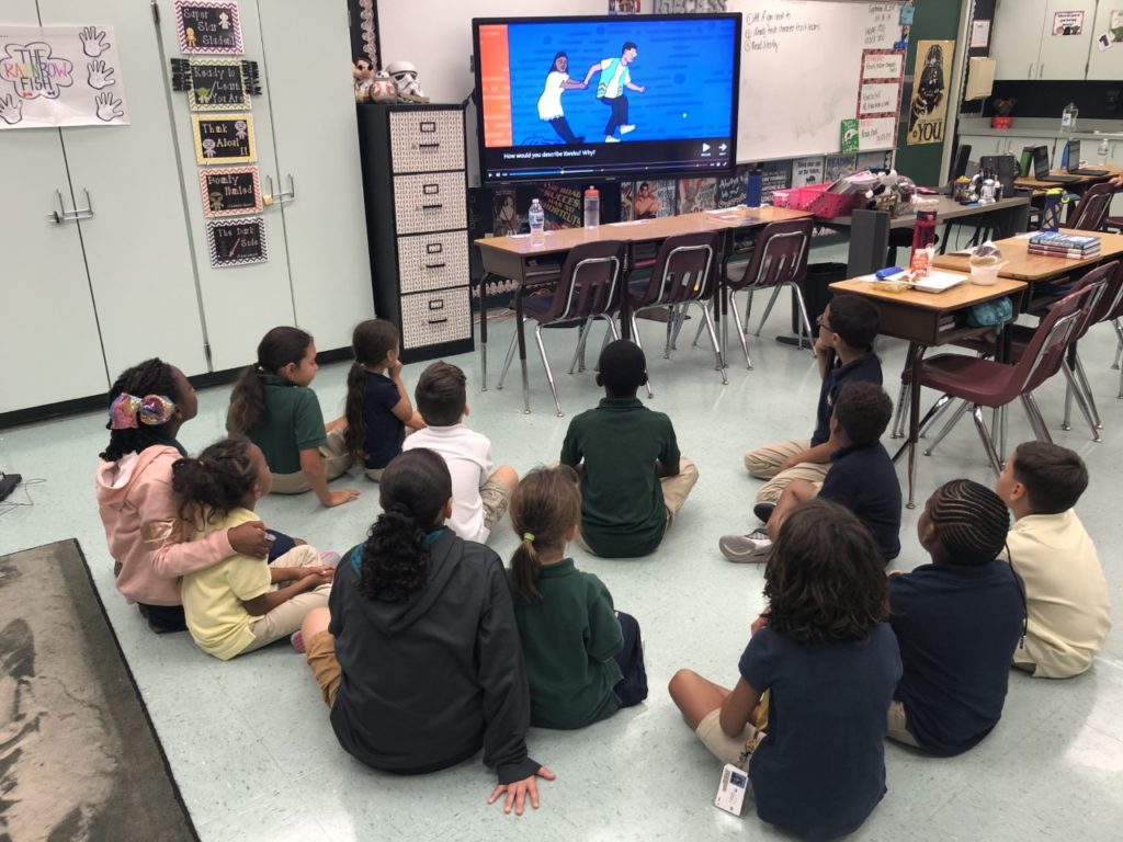 Third graders and kindergarten students buddy up to understand Flocabulary lyrics and learn vocabulary as part of small group instruction